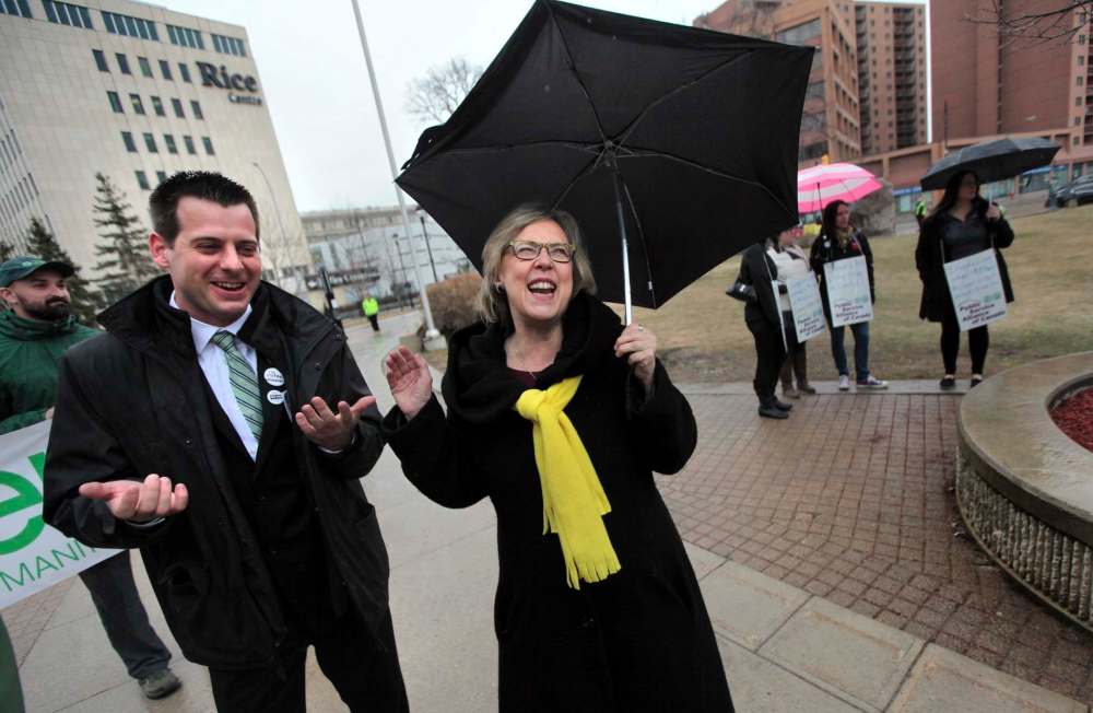 PHIL HOSSACK / WINNIPEG FREE PRESS
Manitoba Green Party leader James Beddome and National Green Party leader Elizabeth May share a laugh despite the rain at a rally for a $15 minimum wage that gathered at the Univercity of Winnipeg Friday at noon before marching down Portage Avenue.