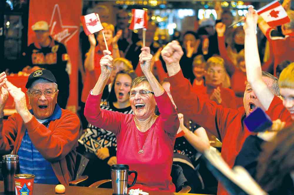 KEN GIGLIOTTI / WINNIPEG FREE PRESS
Annette Lafreniere, her husband, Dennis (left) and Les Oliver join in the celebration at the St. Vital Curling Club Thursday.