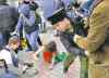 CP
A member of the punk group Pussy Riot lies on the ground as the group is attacked by Cossack militia.
