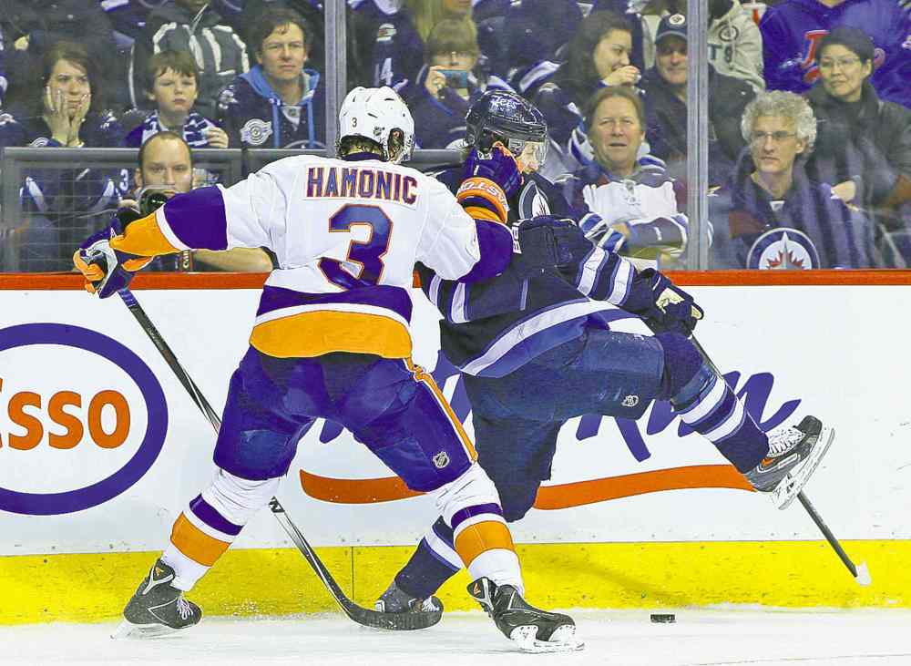 Jason Halstead / Winnipeg Free Press
Islanders defenceman Travis Hamonic slows down Winnipeg forward Bryan Little during second-period action at the MTS Centre Tuesday.
