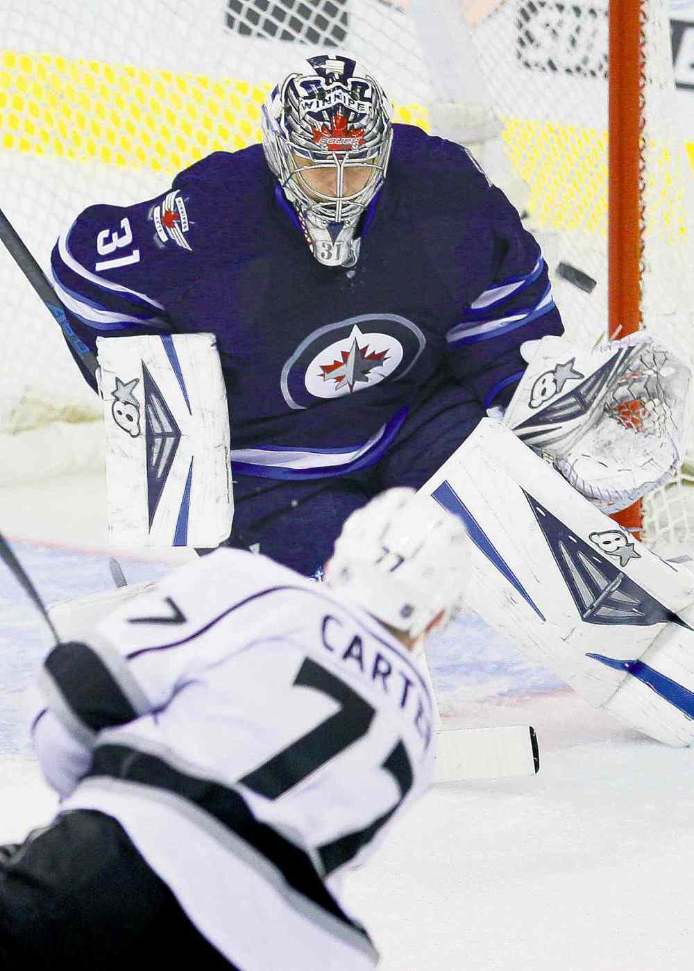 CP
John Woods / the canadian press
L.A.'s Jeff Carter blasts the puck past Winnipeg goaltender Ondrej Pavelec and off the post during first-period action Thursday.