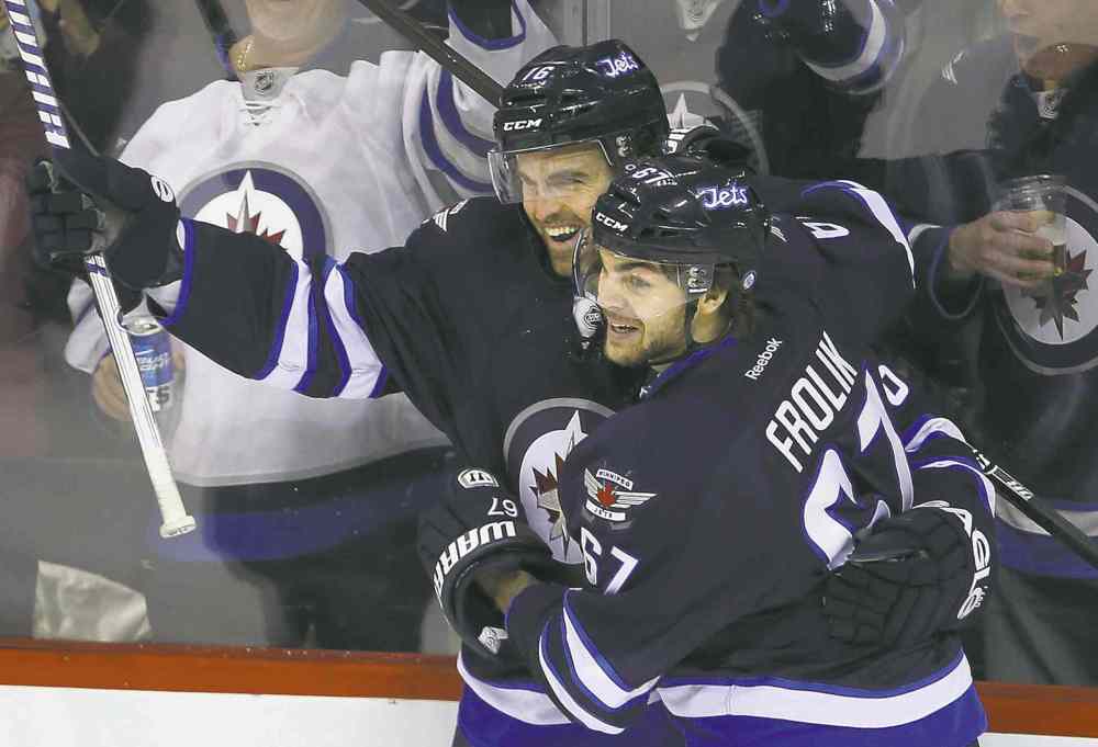 Jets� Andrew Ladd and Michael Frolik celebrate Ladd�s goal against Rangers� goalie Henrik Lundqvist in the first period Friday.