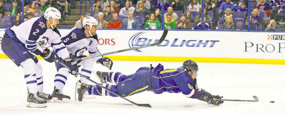 CP
chris lee / the st. louis post-dispatch
St. Louis Blues left-winger Alexander Steen is knocked down by Jets defenceman Mark Stuart (5) as Adam Pardy races in.