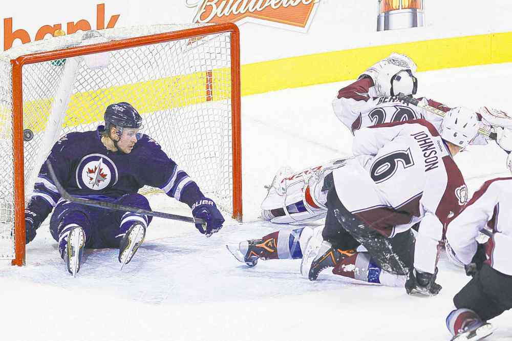 John Woods / The Canadian Press
Winnipeg blue-liner Paul Postma crashes into the net just as Blake Wheeler scores the OT winner Wednesday night.