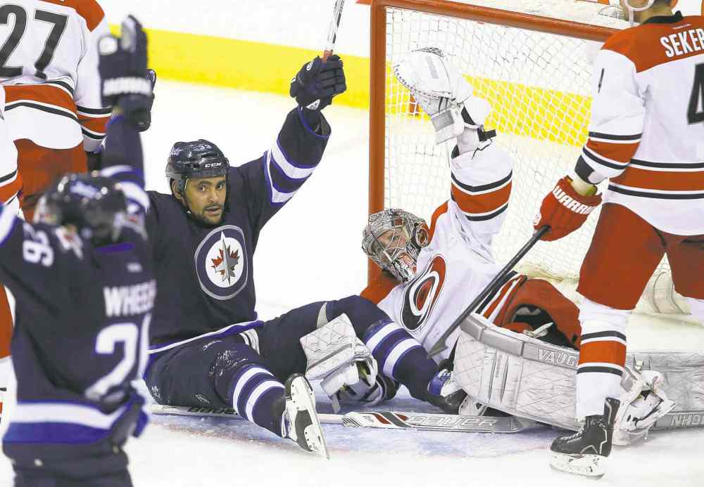 Trevor Hagan / Winnipeg Free Press
Big Buff thinks the Jets have scored — but no. Mark Stuart's shot found the twine behind goalie Cam Ward, but the refs ruled Buff had interfered with Ward.