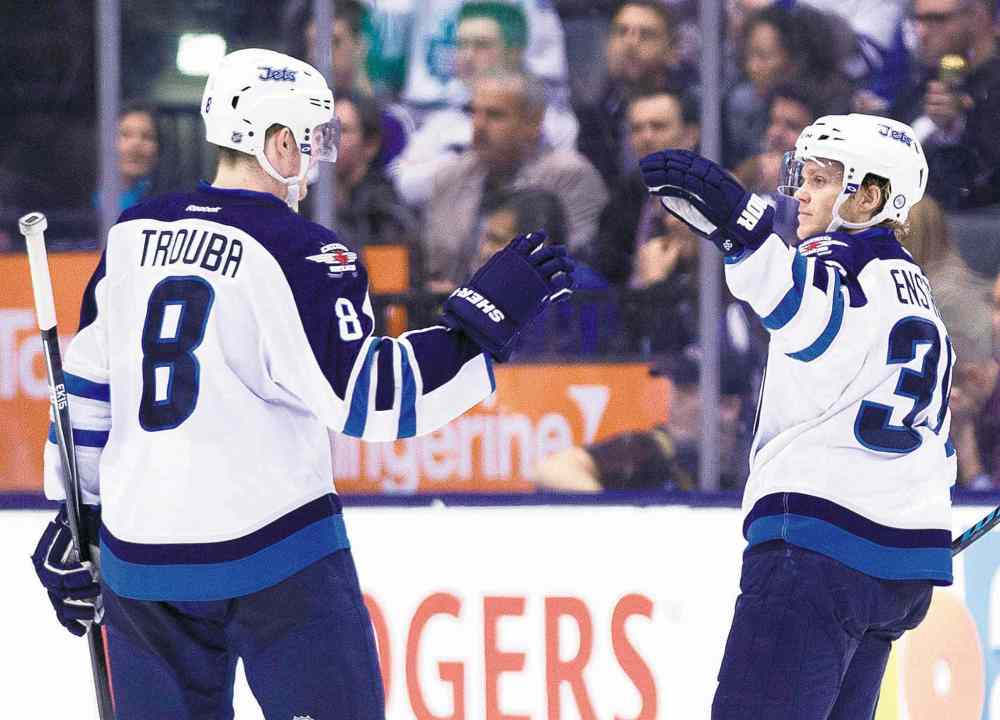 Nathan Denette / The Canadian Press
Winnipeg defenceman Tobias Enstrom (right) celebrates his second-period goal with teammate Jacob Trouba.