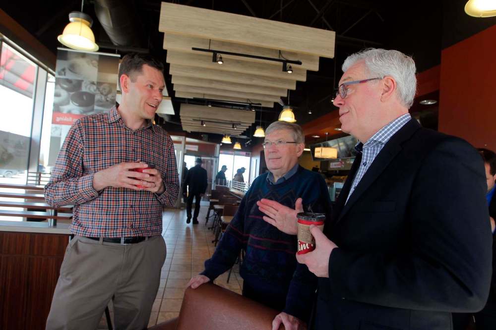 BORIS MINKEVICH / WINNIPEG FREE PRESS
River East NDP candidate Jody Gillis (from left), former MLA Harry Schellenberg and Premier Greg Selinger chat at a Tim Hortons shop on Lagimodiere Boulevard Monday.