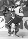 CP
Larry MacDougal / the canadian press
Jets forward Michael Frolik takes out the Flames� Mark Giordano in the first period Friday. Frolik scored the first goal in the Jets� 5-3 win.