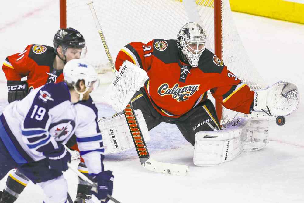 USA Today Sports
Sergei Belski / USA TODAY sports
Calgary Flames goalie Karri Ramo stymies Winnipeg Jets centre Jim Slater during first-period action on Friday night in Calgary. The game wrapped up the Jets� season.