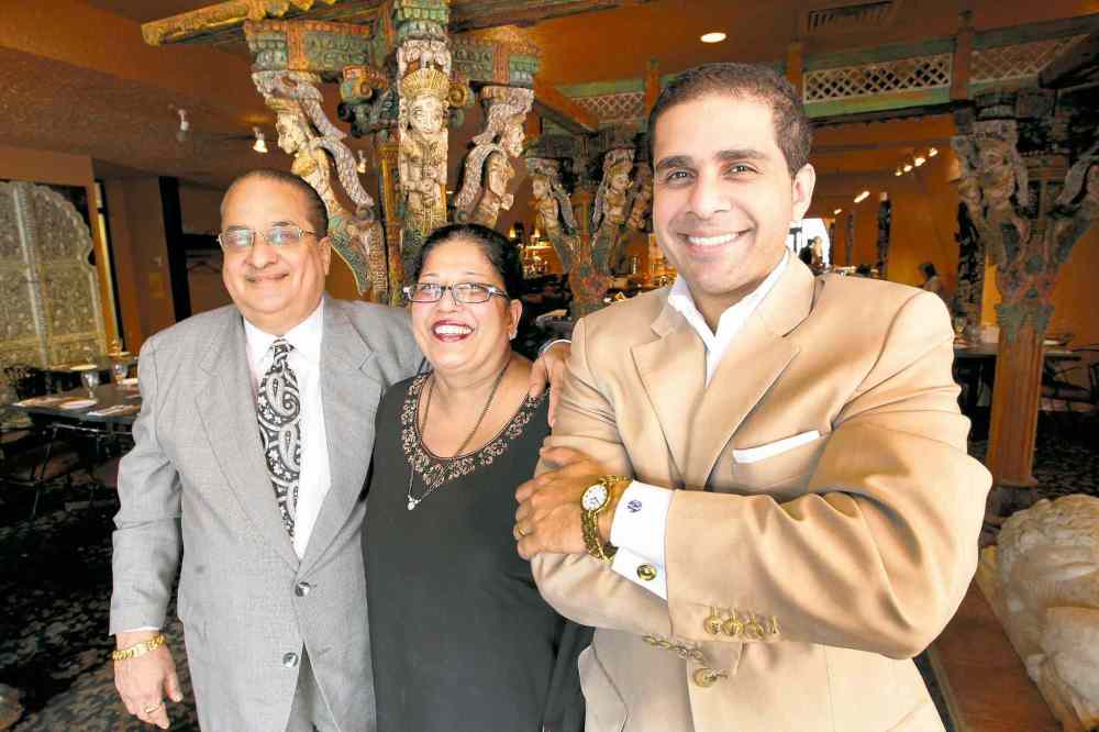 Joe Bryksa / Winnipeg Free Press files
Sachit Mehra (right) with his father Kamal (left and) mother Sudha at the family's East India Company Pub & Eatery restaurant. Sachit is considering running for city council in St. Norbert.