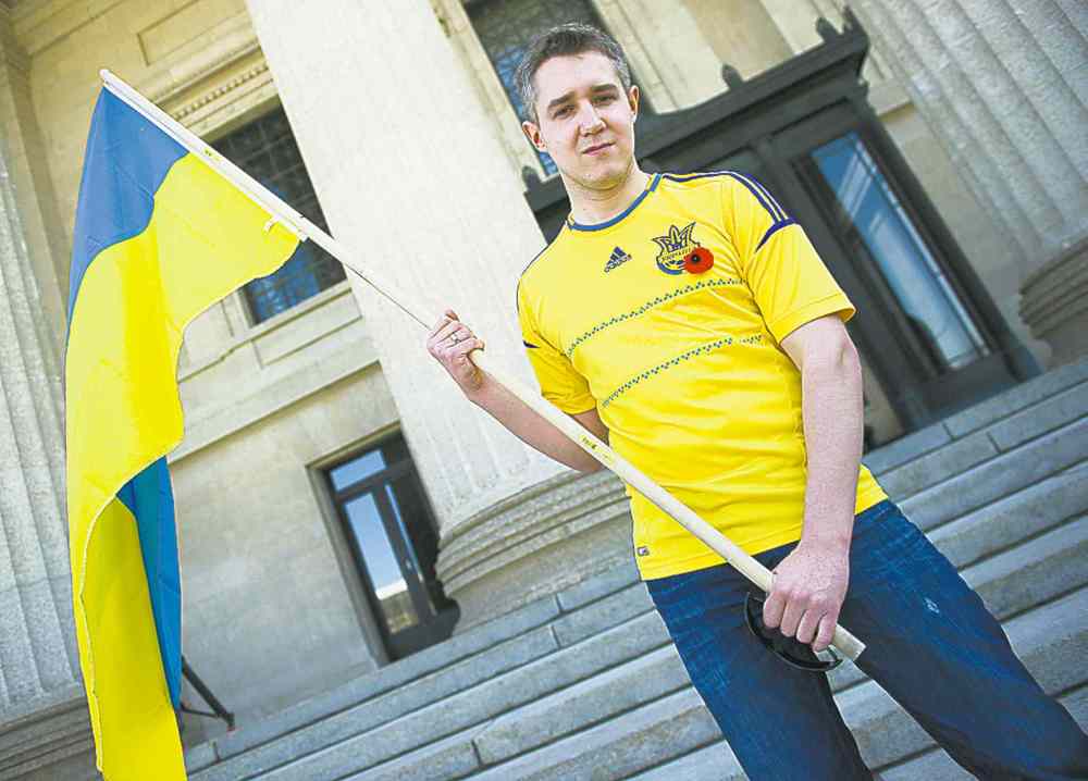 David Lipnowski / Winnipeg Free Press
Ivan Marynovsky holds a Ukrainian flag at Saturday's pro-Russian rally.