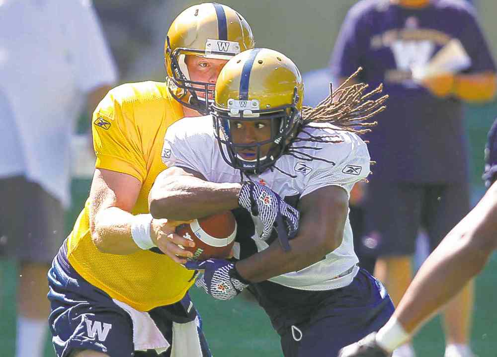 Bomber practice action shot. RB Paris Cotton runs the ball. BORIS MINKEVICH / WINNIPEG FREE PRESS June 3, 2014