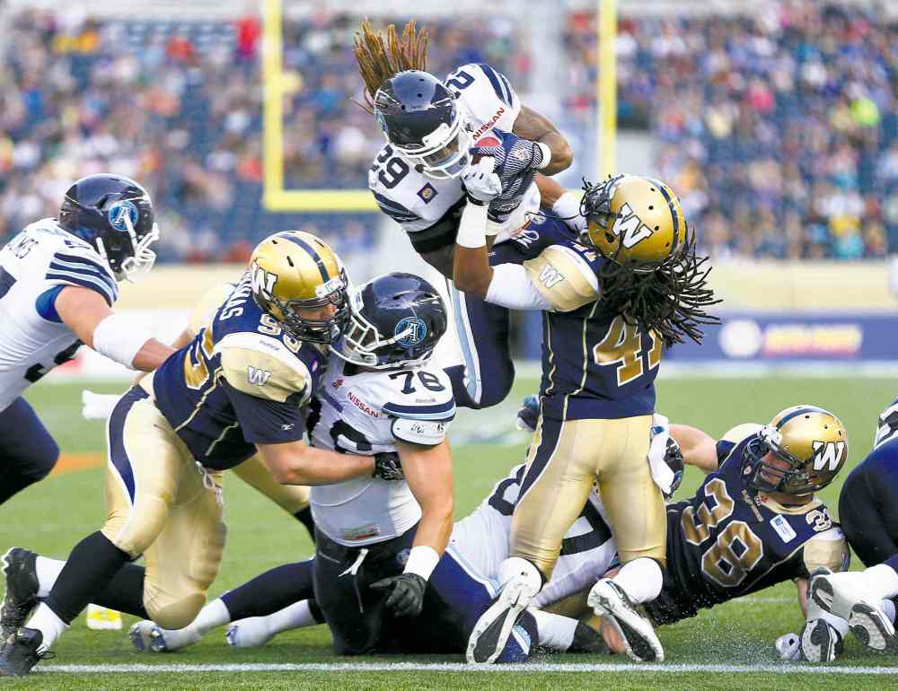 Winnipeg Free Press
Winnipeg Blue Bombers' Don Unamba (41) can't stop Toronto Argonauts' Curtis Steele (29) flying in for the touchdown during the first half of their CFL pre-season game in Winnipeg Monday.