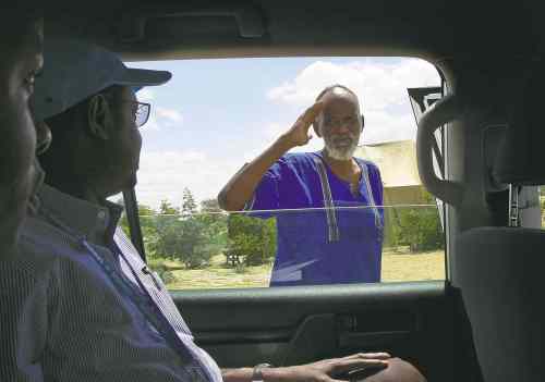 Carol Sanders / Winnipeg Free Press
Ahmed Warsame is well-liked and and respected by both refugees and members of the local community. A refugee salutes him while he drives around Dadaab.