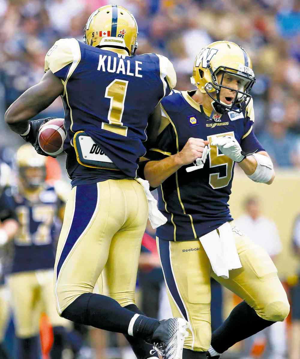 CP
John Woods / the canadian press files
Bombers LB Ejiro Kuale got a shoulder-check from quarterback Drew Willy after recovering a fumble Thursday.