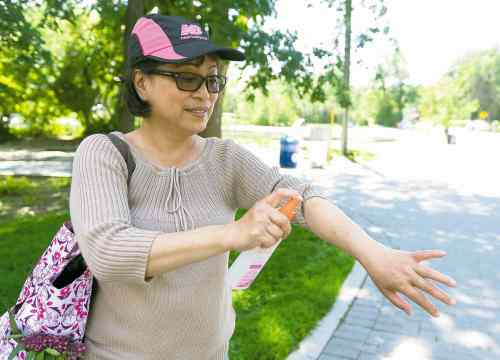 Sarah Taylor / Winnipeg Free Press
Emmellie Velasco sprays herself with mosquito repellent in Assiniboine Park on Saturday.