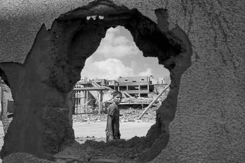 CP
Lefteris Pitarakis / The Associated Press
A Palestinian boy walks past the damaged wall of a house following an Israeli missile attack Tuesday in Rafah, in the southern Gaza Strip.