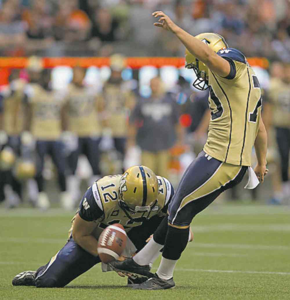 CP
Winnipeg Blue Bombers� Lirim Hajrullahu, right, kicks a field goal as quarterback Brian Brohm holds during the first half of a CFL football game against the B.C. Lions in Vancouver, B.C., on Friday July 25, 2014. THE CANADIAN PRESS/Darryl Dyck
