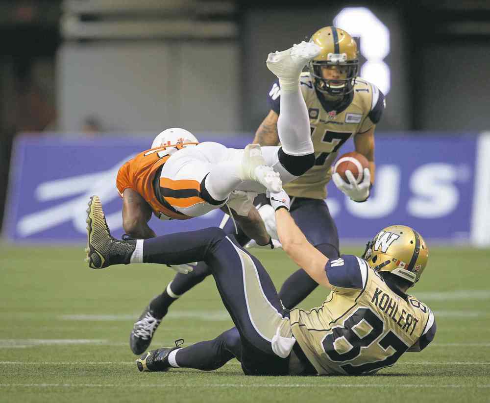 CP
Darryl Dyck / THE CANADIAN PRESS
The B.C. Lions� Dante Marsh (left) collides with the Winnipeg Blue Bombers� Rory Kohlert (bottom) as Nick Moore carries the ball during the first half in Vancouver Friday.