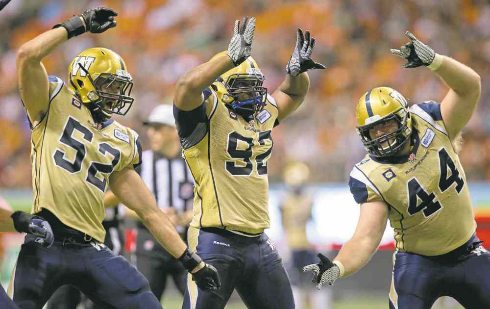The Canadian Press
The Blue's Louie Richardson (from left), Bryant Turner Jr. and Zach Anderson celebrate a sack Friday.