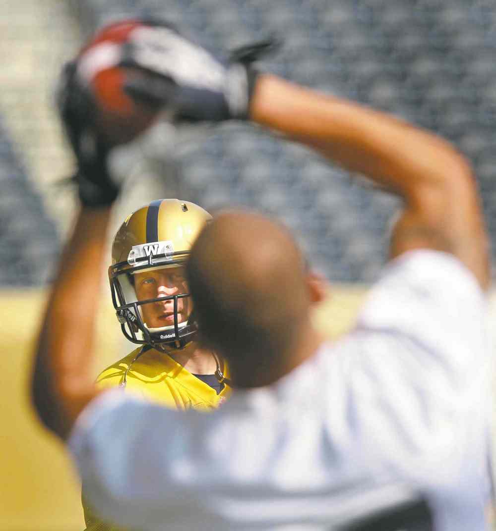 photos by Wayne Glowacki /Winnipeg Free Press
Quarterback Drew Willy tosses to slotback Nick Moore at practice: Players credit Willy for playing well, but say the transformation goes beyond one position. INSET: DB Chris Randle is a key addition helping the Blue and Gold pressure opposing pivots.