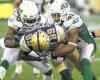 Phil Hossack / Winnipeg Free Press
Winnipeg Blue Bombers receiver Clarence Denmark plows through Saskatchewan Roughriders Weldon Brown (left) and Tyron Brackenridge Thursday night.