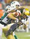 John Woods / The Canadian Press
Bombers receiver Julian Feoli-Gudino can't hang onto the ball after absorbing a thundering hit from Saskatchewan Roughrider Tyron Brackenridge.
