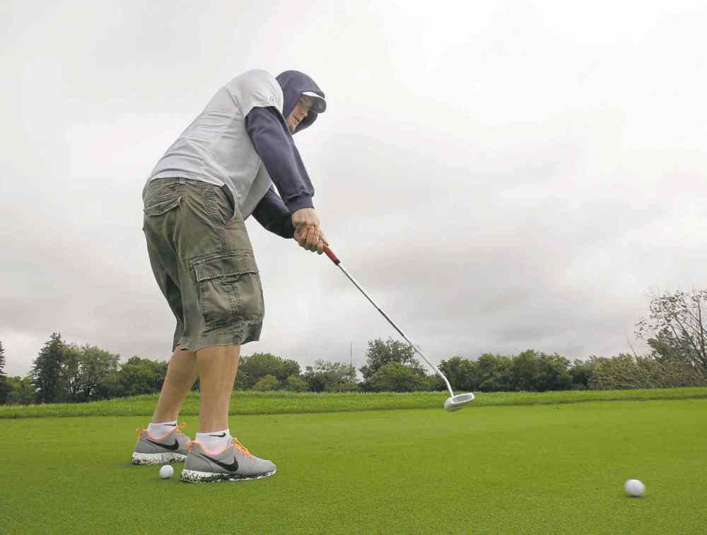 Linebacker Kyle Norris practises his putting Monday at Southwood.