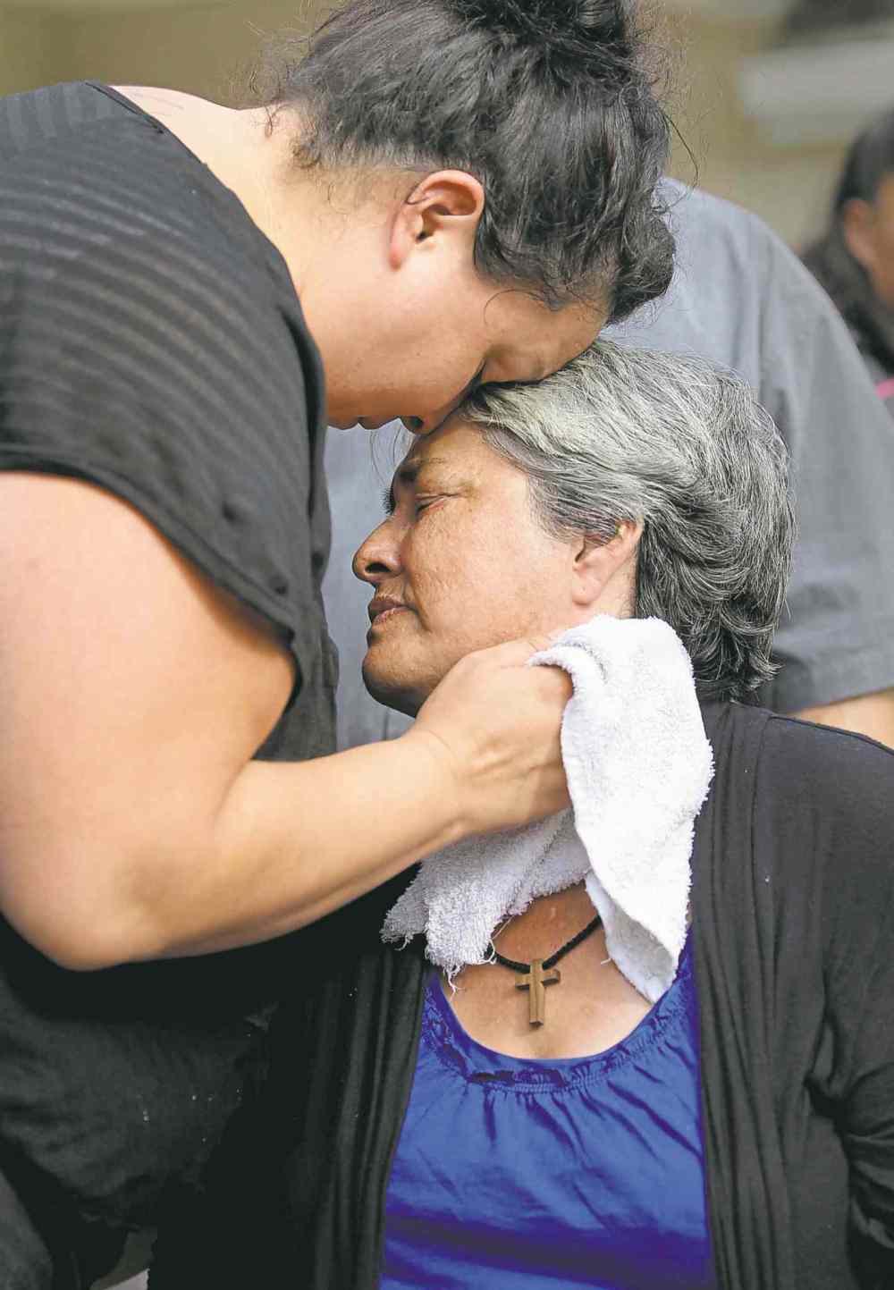 Thelma Favel is comforted by her daughter, Samatha Barto, after her grand-niece's funeral.