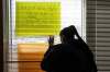 MIKE DEAL / WINNIPEG FREE PRESS
Lisa Strong, an Anishinabe Ikwe Ojibway woman, looks outside a window covered in posters in the INAC office on Hargrave Street Monday afternoon. For nearly two weeks, groups of indigenous protesters have occupied INAC offices in Winnipeg, Toronto and Vancouver. Similar protests have been staged in Regina and Gatineau, Que.