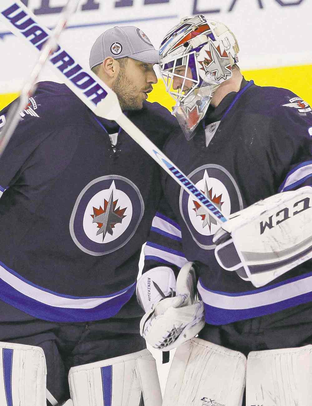 John Woods / The Canadian Press Files
Michael Hutchinson (right) celebrates his first NHL win with Ondrej Pavelec, a shootout win over the Boston Bruins in April.