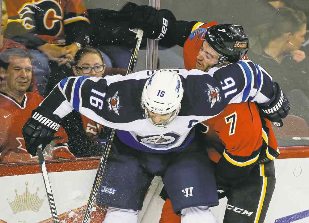 CP
Jeff McIntosh / the canadian press
Jets captain Andrew Ladd (left) roughs it up with Calgary�s TJ Brodie during first-period pre-season action at the Saddledome Thursday night.