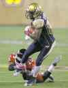 TREVOR HAGAN / WINNIPEG FREE PRESS
Winnipeg receiver Clarence Denmark tries vainly to elude the grasp of Calgary defender Keon Raymond during second-half action Saturday night.