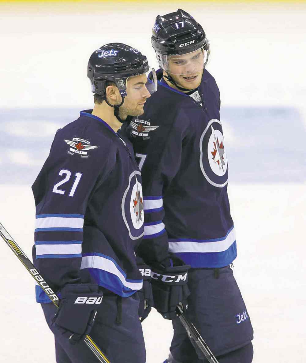 Trevor Hagan / Winnipeg Free Press
Jets T.J. Galiardi (21) and Adam Lowry chat after Lowry's goal.