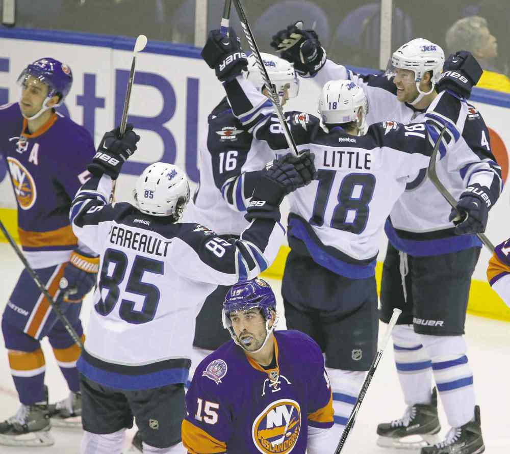 trevor hagan / winnipeg free press
Jets Mathieu Perreault (85), Andrew Ladd (16), Bryan Little (18) and Paul Postma (4) celebrate after Postma scored the Jets� second goal Tuesday.