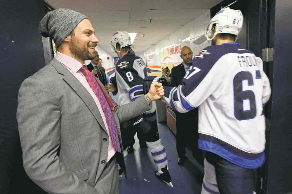 TREVOR HAGAN / WINNIPEG FREE PRESS files
Injured defenceman Zach Bogosian (left) congratulates Jacob Trouba and Michael Frolik after the Jets beat the Islanders Tuesday night.