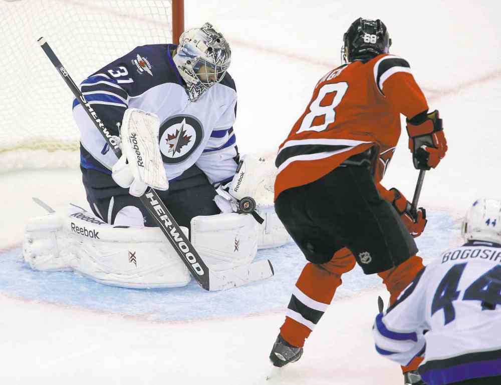 TREVOR HAGAN / WINNIPEG FREE PRESS
Winnipeg goaltender Ondrej Pavelec shuts the door on New Jersey star Jaromir Jagr during second-period action Thursday night.