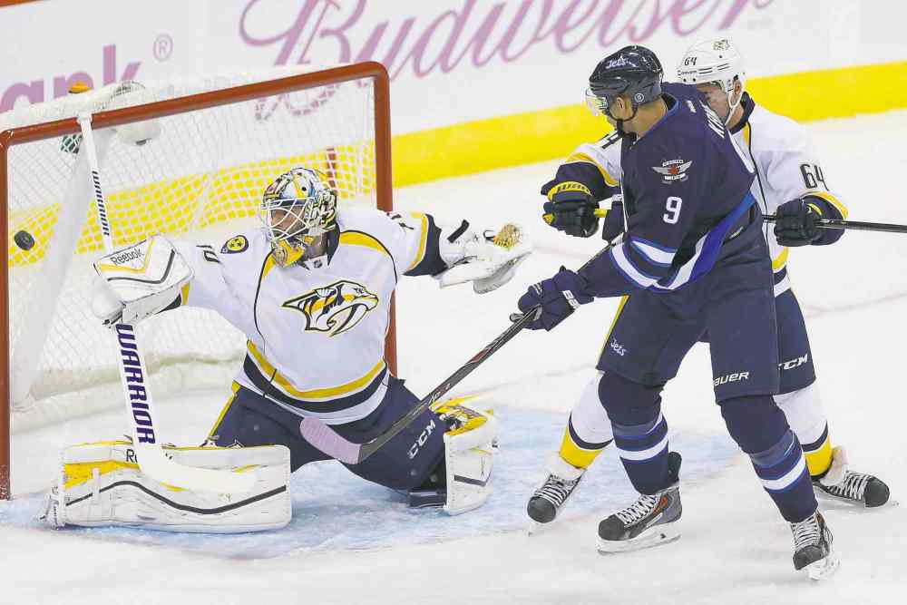 CP
john woods / the canadian press
Jets winger Evander Kane watches as a shot by Mark Scheifele (not shown) gets past Predators goalie Carter Hutton for the game-winner Tuesday.