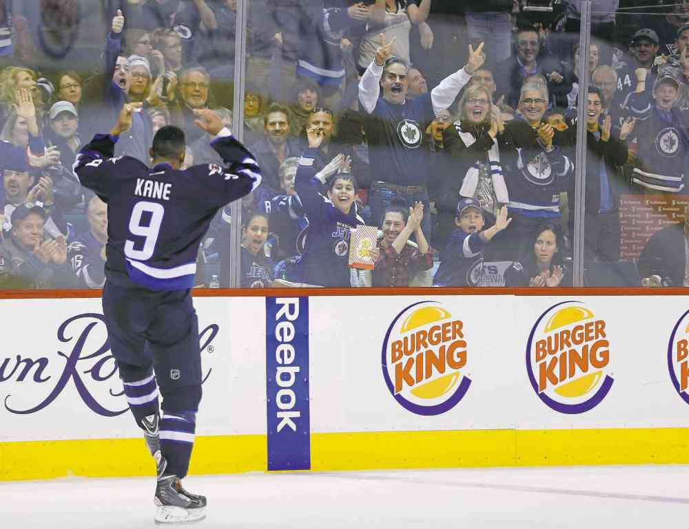 John Woods / the canadian press
Jets left-winger Evander Kane exhorts the crowd after duking it with Pittsburgh Penguin Simon Despres in the second period.