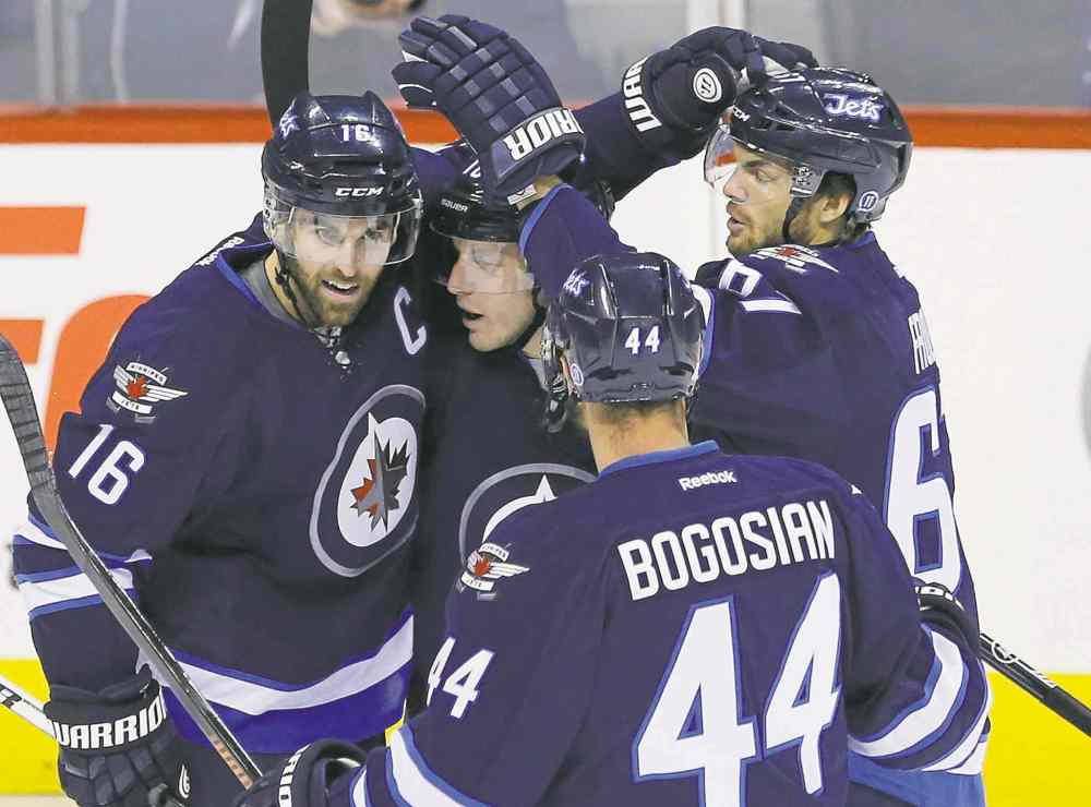 John Woods / the canadian press
Winnipeg's Andrew Ladd (16), Bryan Little (centre), Zach Bogosian (44) and Michael Frolik (right) celebrate Ladd's first-period goal against the Penguins Thursday.