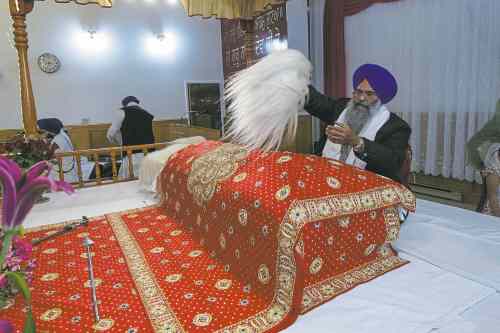 MIKE DEAL / WINNIPEG FREE PRESS
A member of the congregation at the Sikh Society of Manitoba waves a whisk -- a traditional show of respect �-- over the Guru Granth Sahib Thursday.
