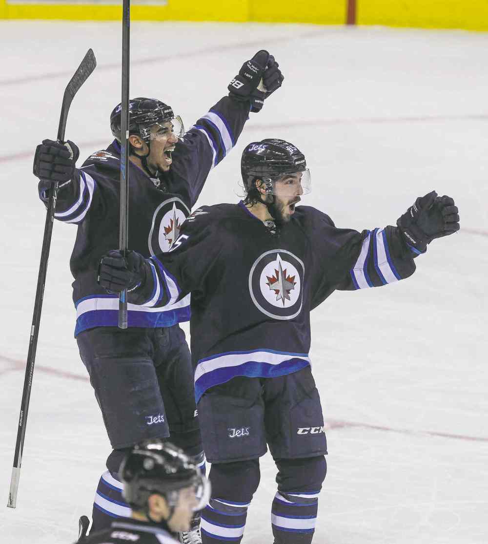 MIKE DEAL / WINNIPEG FREE PRESS
MIKE DEAL / WINNIPEG FREE PRESS
Overtime hero Mathieu Perreault (right) celebrates his game-winning goal with linemate Evander Kane Wednesday night at the MTS Centre.