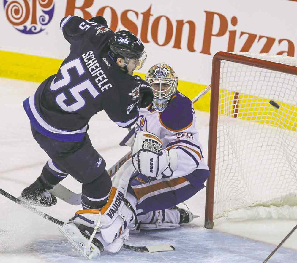 MIKE DEAL / WINNIPEG FREE PRESS files
Jets centre Mark Scheifele centre crashes into Oilers goaltender Ben Scrivens during Wednesday's overtime win at the MTS Centre.