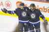 John Woods / Winnipeg Free Press
Winnipeg Jets forward cum blue-liner Dustin Byfuglien (right) and Blake Wheeler celebrate Byfuglien's first-period power-play goal Sunday against the Anaheim Ducks.