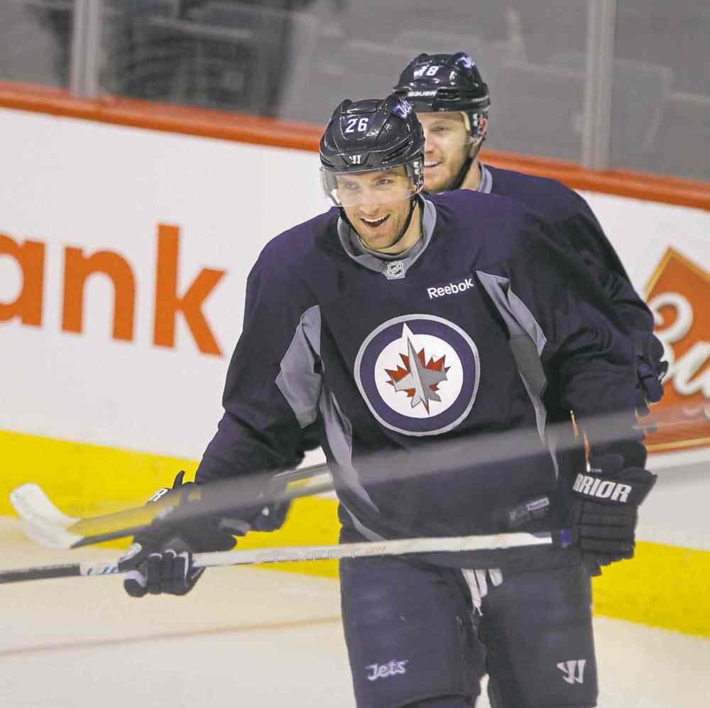 wayne glowacki / winnipeg free press
Blake Wheeler (left) and Bryan Little skate at Monday�s practice before heading out for Dallas.