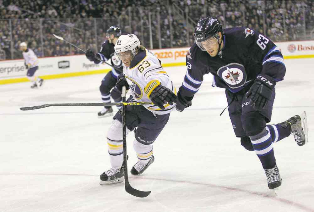 Phil Hossack / Winnipeg Free Press
Rookie Jets blue-liner Ben Chiarot races Buffalo forward Tyler Ennis for the puck in the Winnipeg zone during Tuesday night's action.