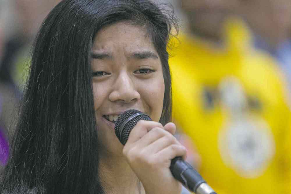MIKE DEAL / WINNIPEG FREE PRESS
Maria Aragon sings the national anthems as almost 1,000 basketball players gathered Sunday to take part in the opening ceremonies for the Philippine Basketball Association Winnipeg Basketball League. 141123 - Tuesday, November 25, 2014 - (MIKE DEAL / WINNIPEG FREE PRESS)
