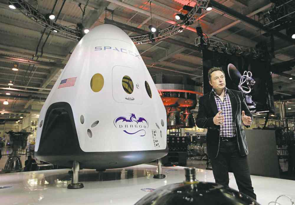 jae hong / the associated press files
Elon Musk introduces the SpaceX Dragon V2 spaceship at the SpaceX headquarters in Hawthorne, Calif. Musk is working to reuse rockets to help reduce the cost of space travel and make landing on other planets with people more viable.
