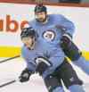 Wayne Glowacki / Winnipeg Free Press
Toby Enstrom (left) and Mark Stuart were wearing baby-blue no-contact practice jerseys Tuesday.