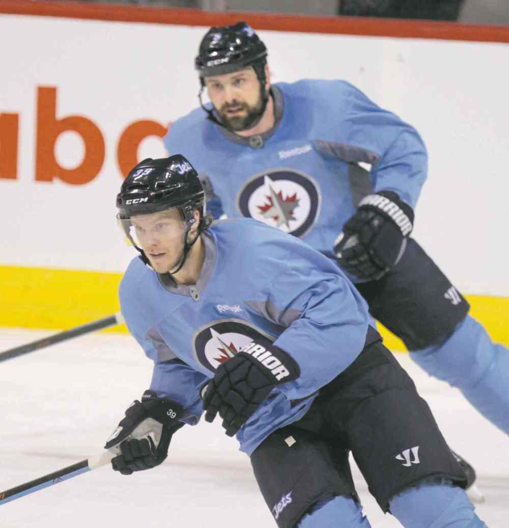 Wayne Glowacki / Winnipeg Free Press
Toby Enstrom (left) and Mark Stuart were wearing baby-blue no-contact practice jerseys Tuesday.